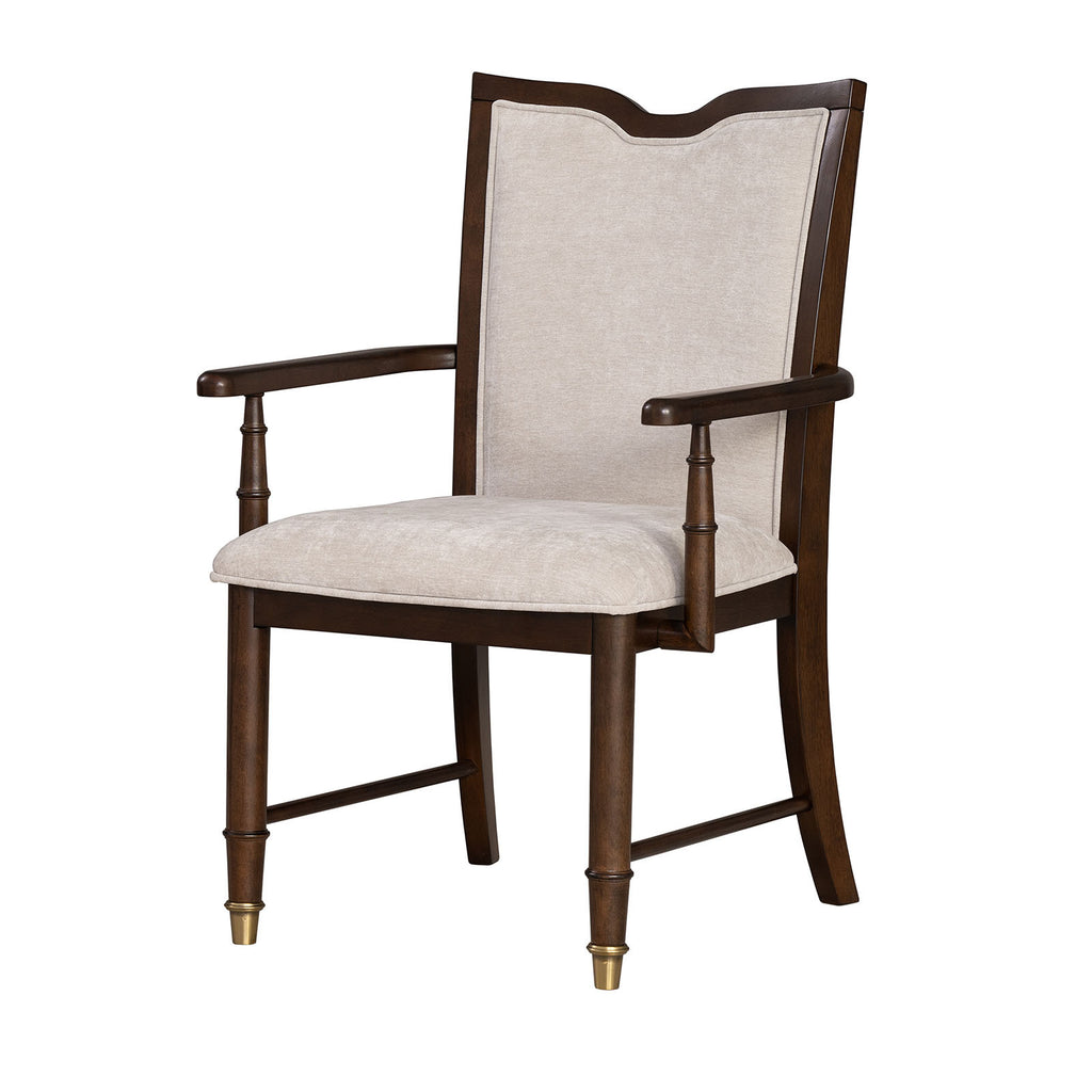 Angled view of transitional dining arm chair with beige fabric and dark cherry wood frame, emphasizing classic elegance.
