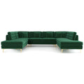 U-shaped sectional sofa in lush green velvet with tufted backrests, accent pillows, and slender gold metal legs.