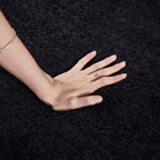 Close-up of hand pressing into soft chenille fabric of Modern Black Modular Sofa, demonstrating plush texture and comfort.