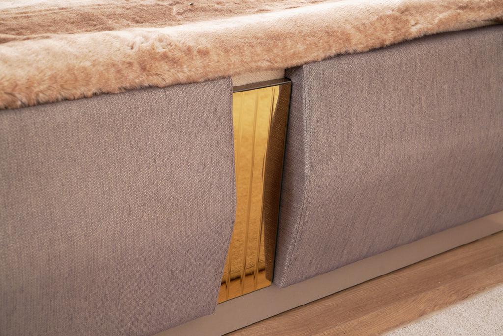 Gold-accented center panel on Lorenzo Queen Bed footboard, framed by soft gray fabric for a refined modern look.