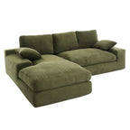 Full view of green corduroy sofa with chaise, cushions, and pillows, featuring a modern L-shape design perfect for compact living spaces.