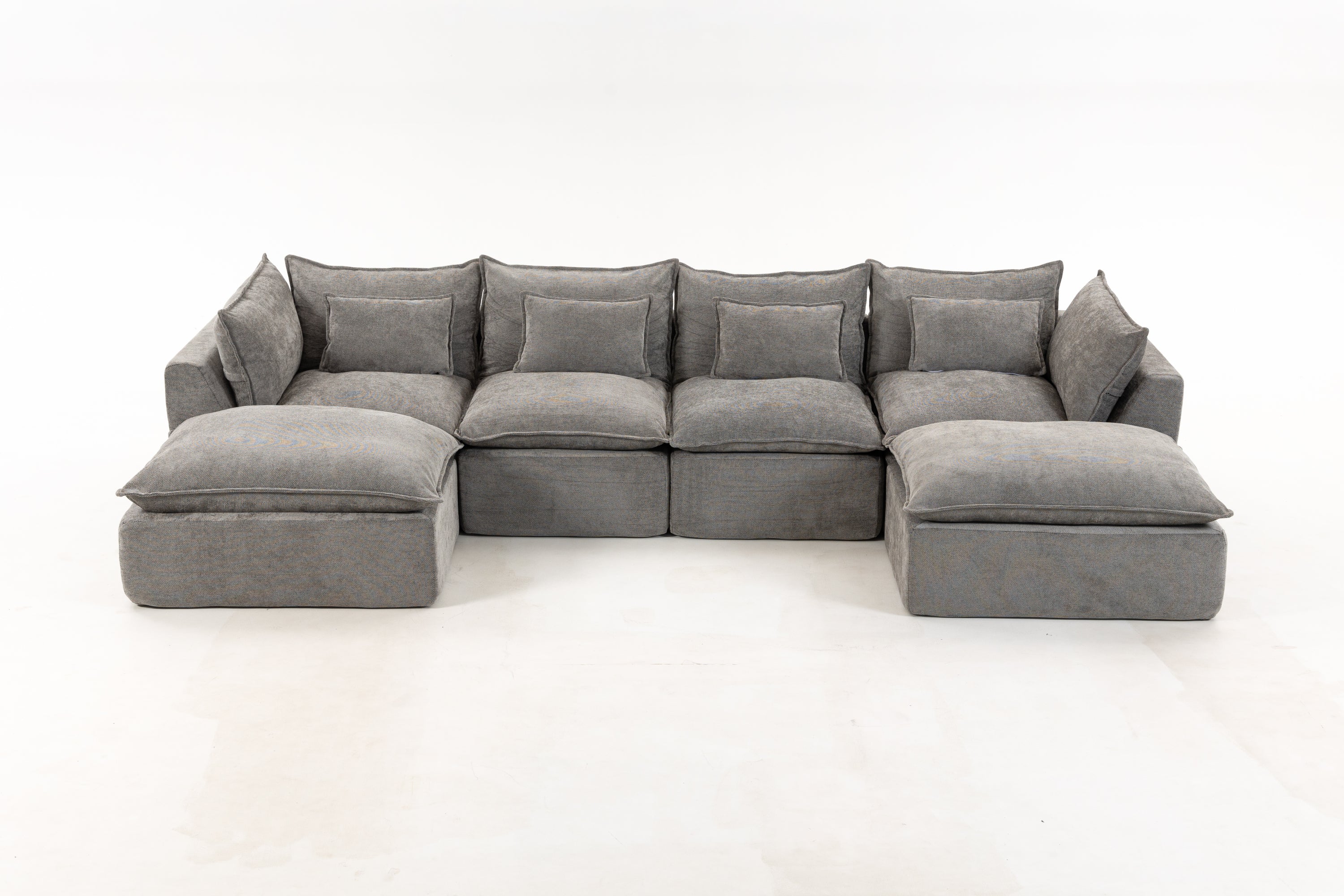 Front view of oversized modular sectional sofa in grey velvet featuring deep seating and cloud-like comfort for modern living rooms.