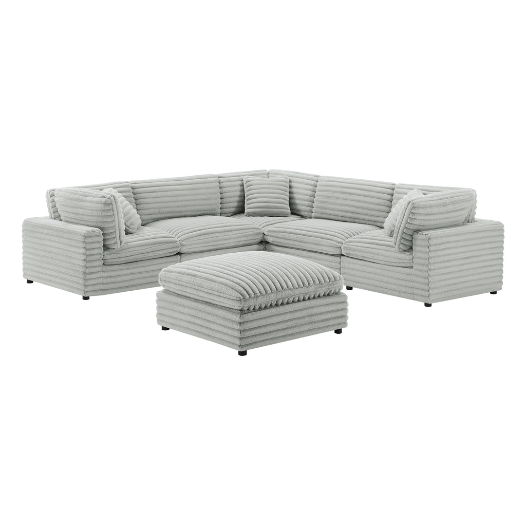 Six-piece modular sectional in plush gray corduroy-style polyester with a matching ottoman, isolated on white.