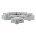 Six-piece modular sectional in plush gray corduroy-style polyester with a matching ottoman, isolated on white.