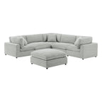Six-piece modular sectional in plush gray corduroy-style polyester with a matching ottoman, isolated on white.