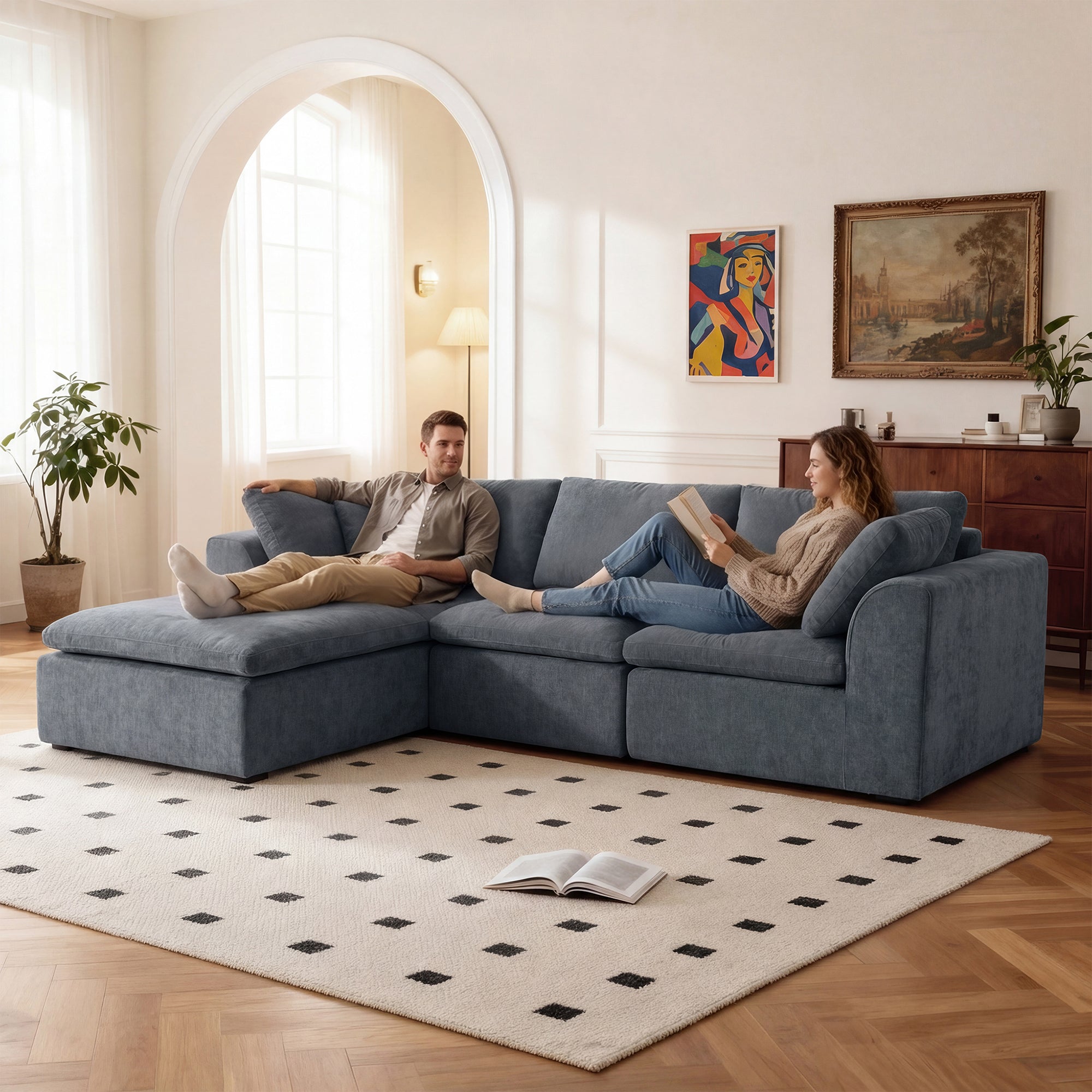 Couple relaxing on modern L-shaped sectional sofa with chaise lounge, upholstered in premium blue chenille, ideal for cozy living spaces.