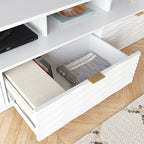 Close-up of open drawer in White Coastal Credenza, showing interior storage with folded blanket and books, ideal for living room use.