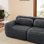 Side view of dark grey Modular Plush Sectional Sofa with chaise, placed in a cozy living room with natural lighting.
