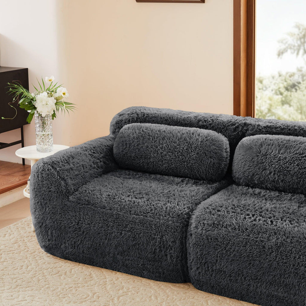 Side view of Modular Plush Sofa - Dark Grey in a home setting. Includes soft back cushions and a non-slip base.