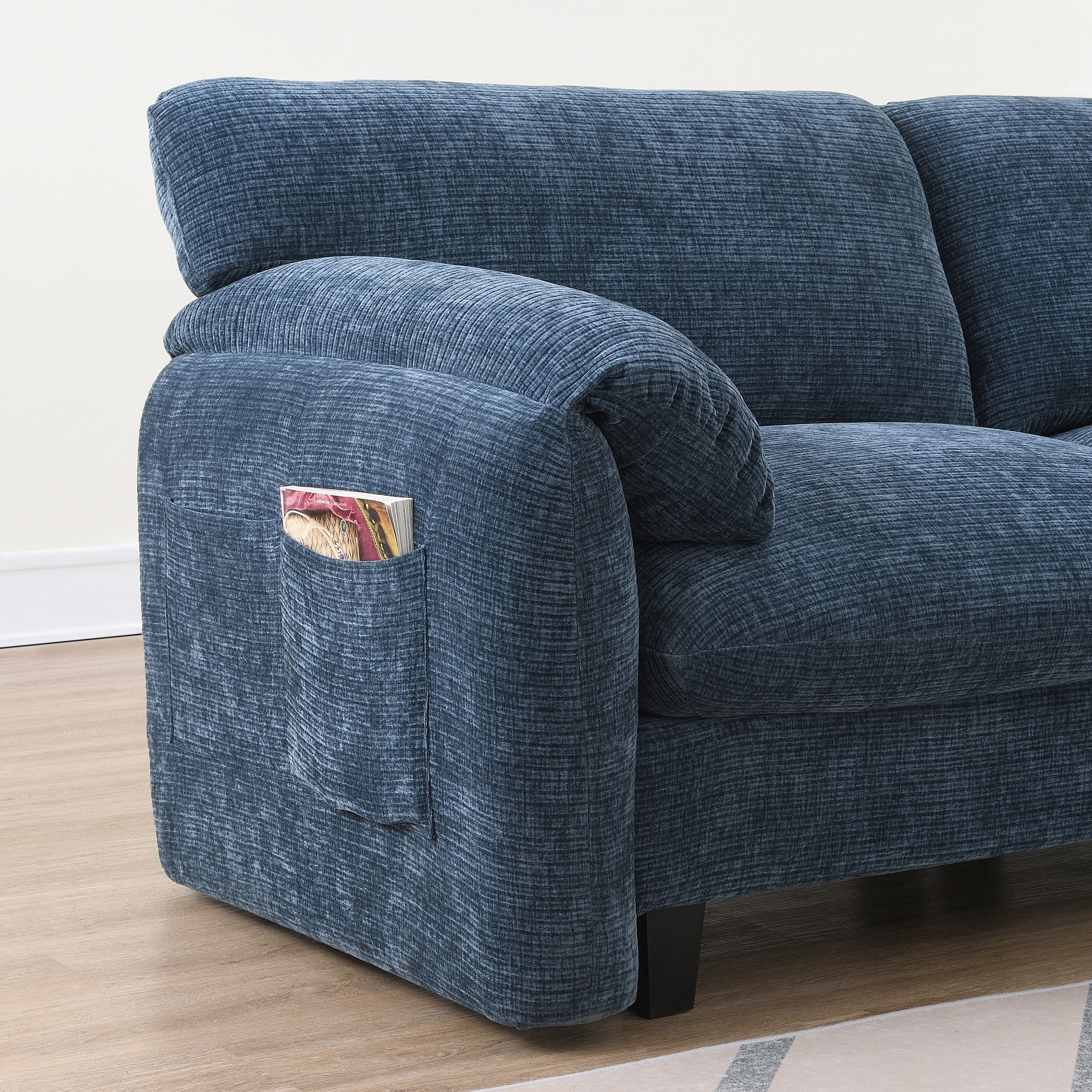 Side pocket on modular sofa armrest for storing magazines or remotes, blending convenience with modern design.