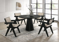 Jasper Dining Set - 5-Piece Ebony Black with pedestal base and fabric chairs in modern dining room. Ideal for contemporary interiors.