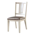 Padded seat dining chair in white oak finish with a faceted back design. Blends traditional and modern aesthetics for dining room use.