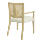 Rear angled view of rattan back dining chair with light wood frame and cushioned seat, showcasing mid-century modern craftsmanship.