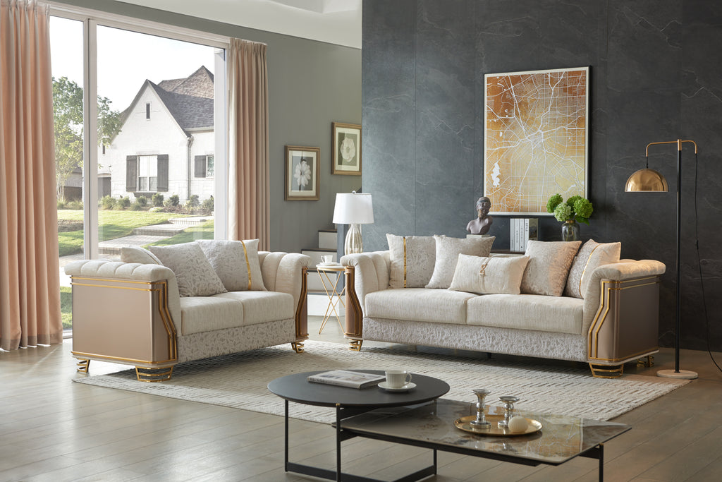Two-tone cream living room set featuring upholstered sofas with modern gold stainless steel accents and patterned bases.