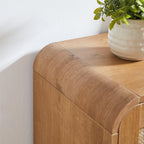 Rounded corner detail of rattan shoe cabinet in natural wood finish. Smooth edges enhance safety and modern design appeal.