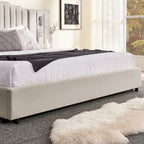 Lower corner of king bed frame showing upholstered base and soft bedding, highlighting no box spring design and solid construction.