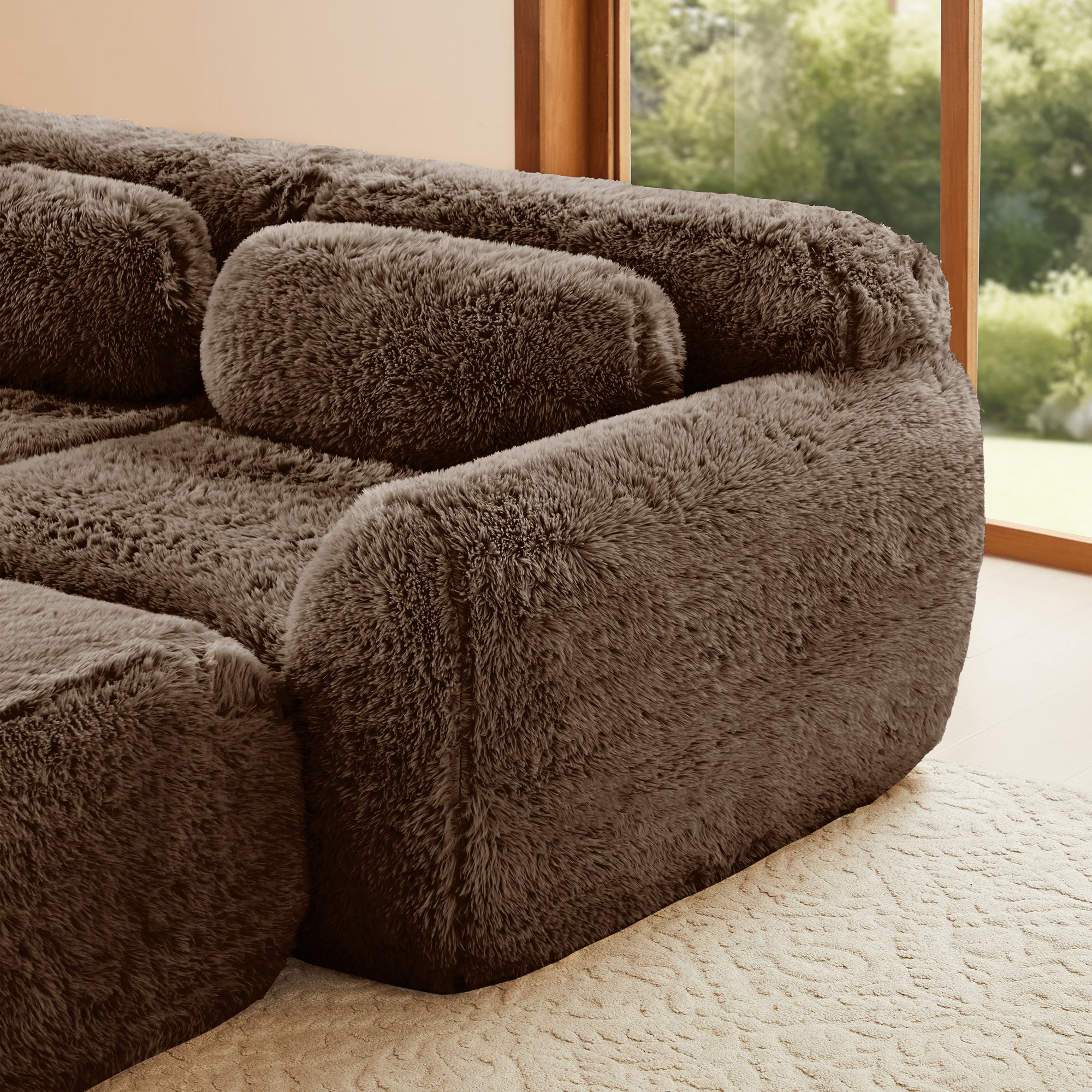 Close-up of armrest on plush brown 2-seater modular sofa, showing soft fabric and ergonomic design.