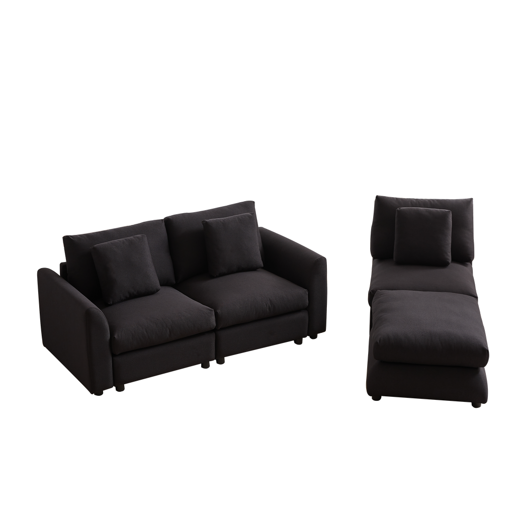 Modular sofa with ottoman in L-shaped layout, featuring 3 seat cushions and pillows in dark fabric, ideal for modern living rooms or apartments.