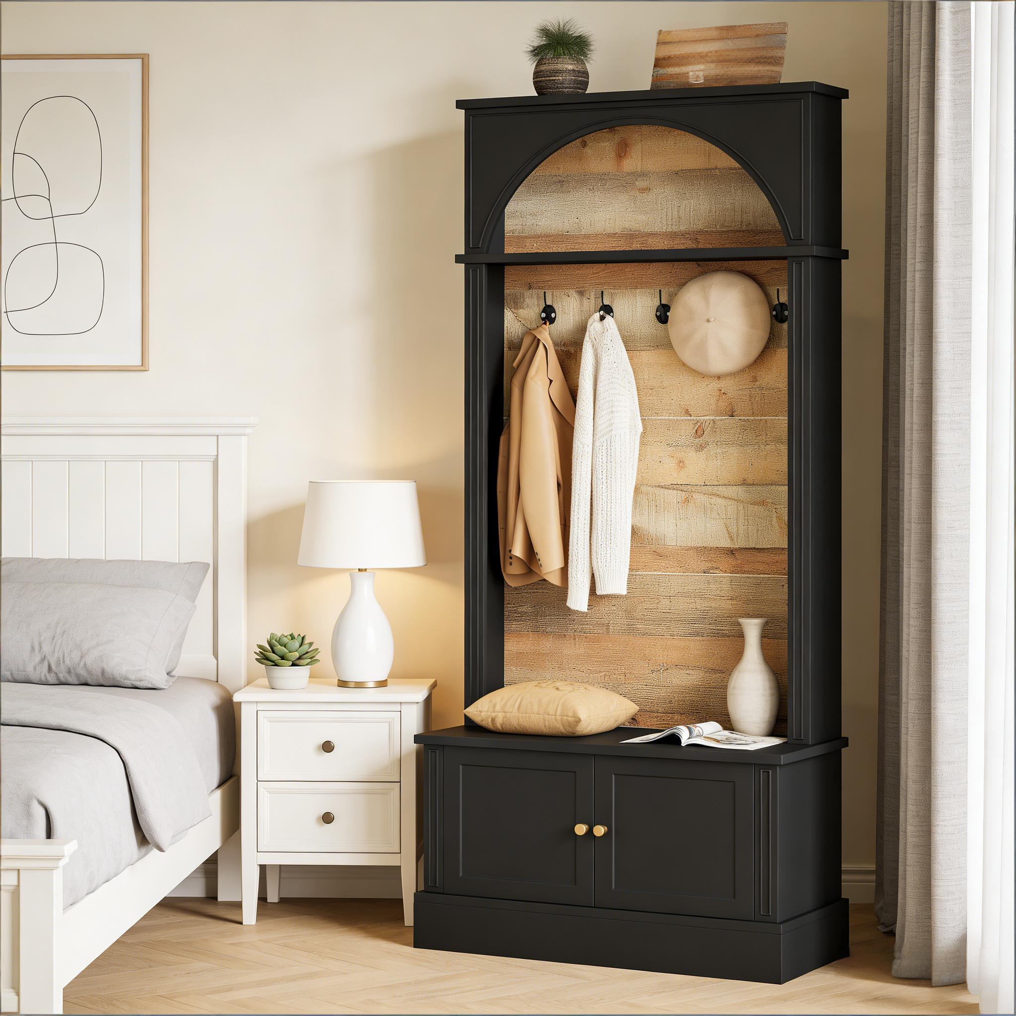 Black arched hall tree with a rustic wood-plank back, coat hooks, and a two-door storage bench base.