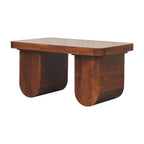 Angled view of chunky solid wood coffee table with bold curved legs and chestnut finish, ideal for modern living rooms.
