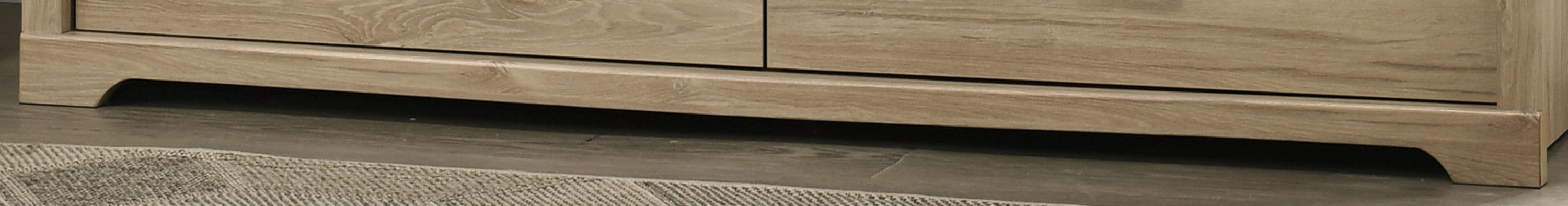 Base detail of Elara Light Oak 6-Drawer Dresser with subtle curved skirting for a refined modern look.