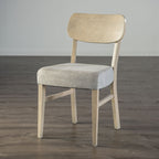 Front-facing transitional dining chair in gray with padded seat and light wood frame, perfect for versatile decor.