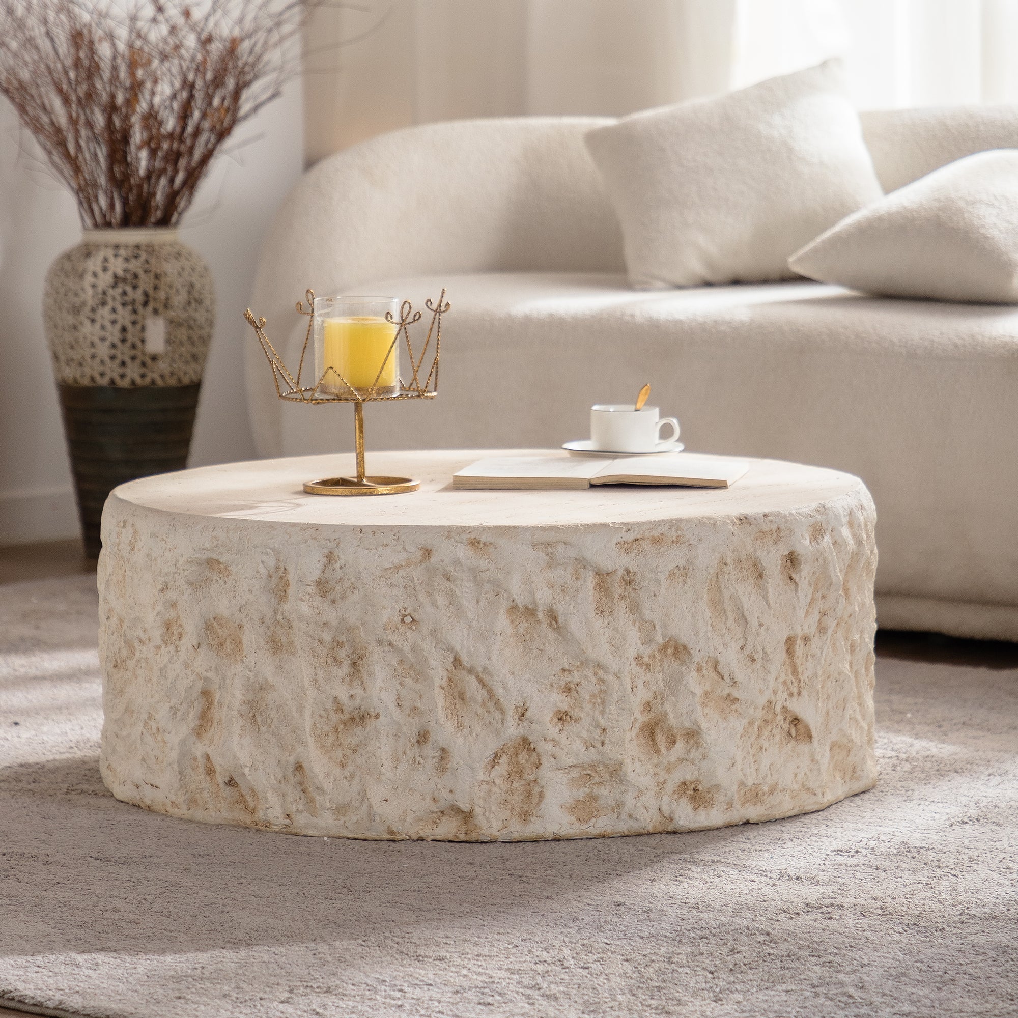 Mid-Century MgO Coffee Table with faux stone texture in a cozy living room. Round design complements modern and rustic décor styles.