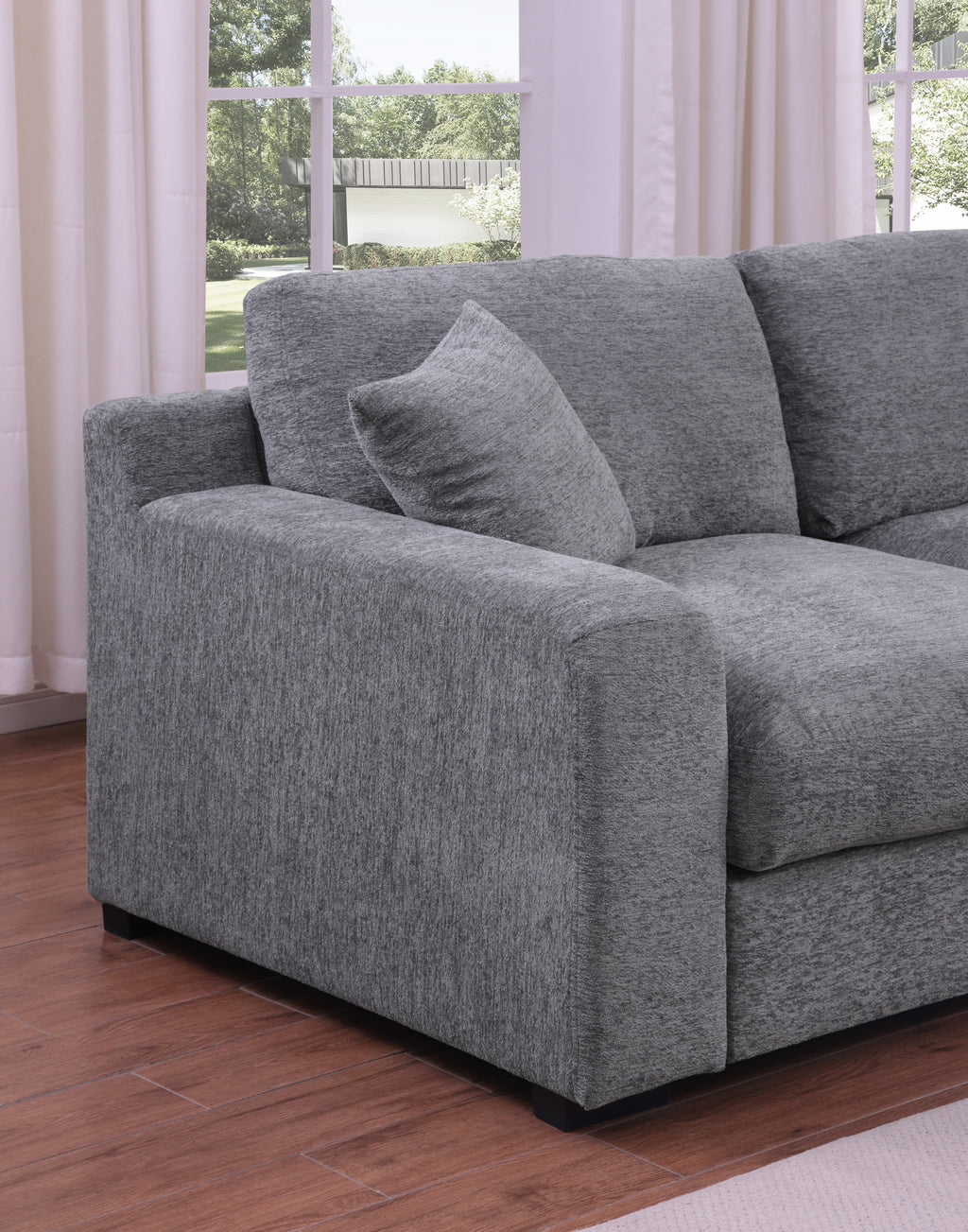 Armrest and cushion detail of light gray chenille sectional sofa. Soft texture and supportive design for everyday comfort.