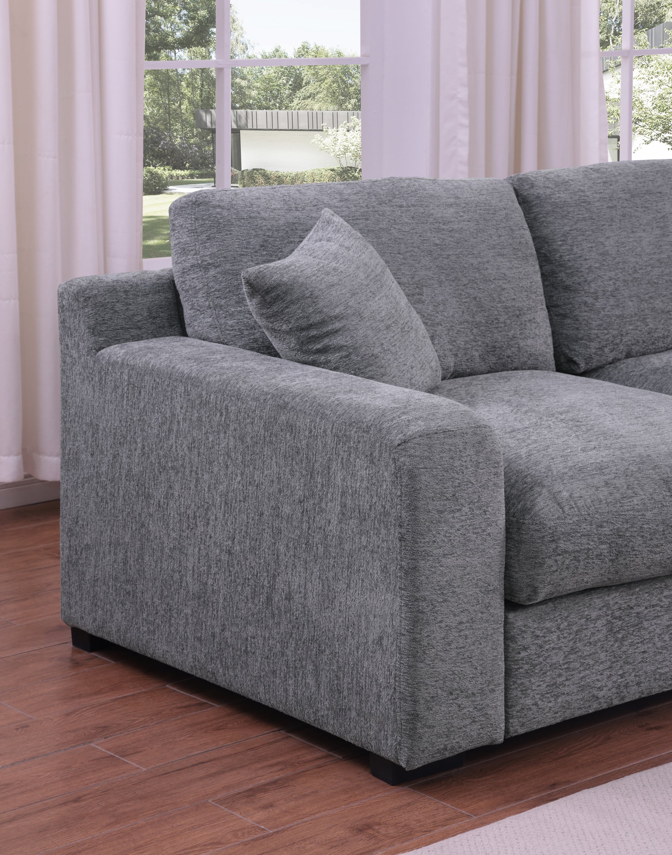 Armrest and cushion detail of light gray chenille sectional sofa. Soft texture and supportive design for everyday comfort.