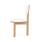 Side profile of polyester dining chair showing thick cushioned seat and circular backrest.