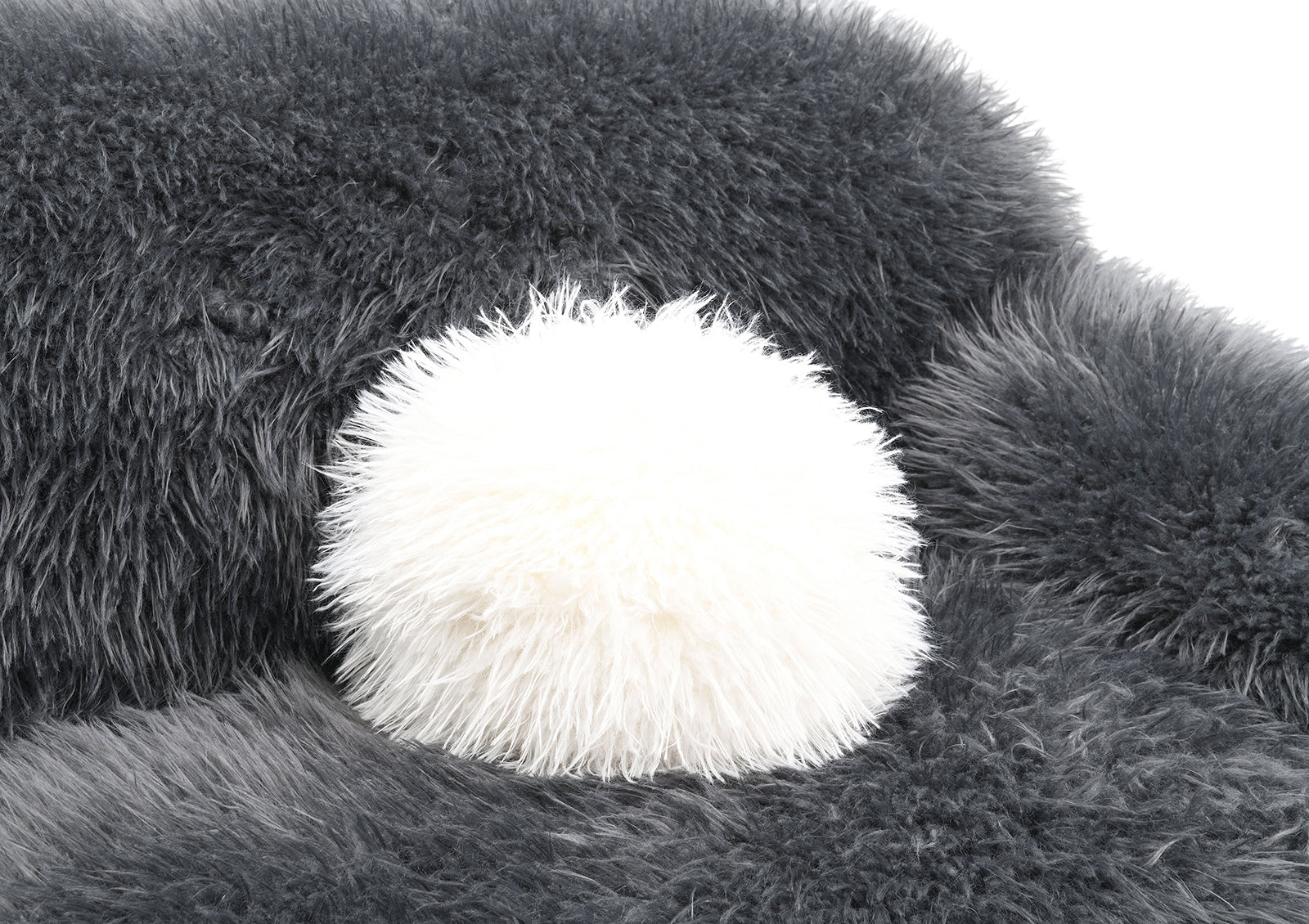 Detail of white faux fur pillow on the Dark Gray Accent Swivel Chair. Adds contrast and extra comfort to the contemporary design.