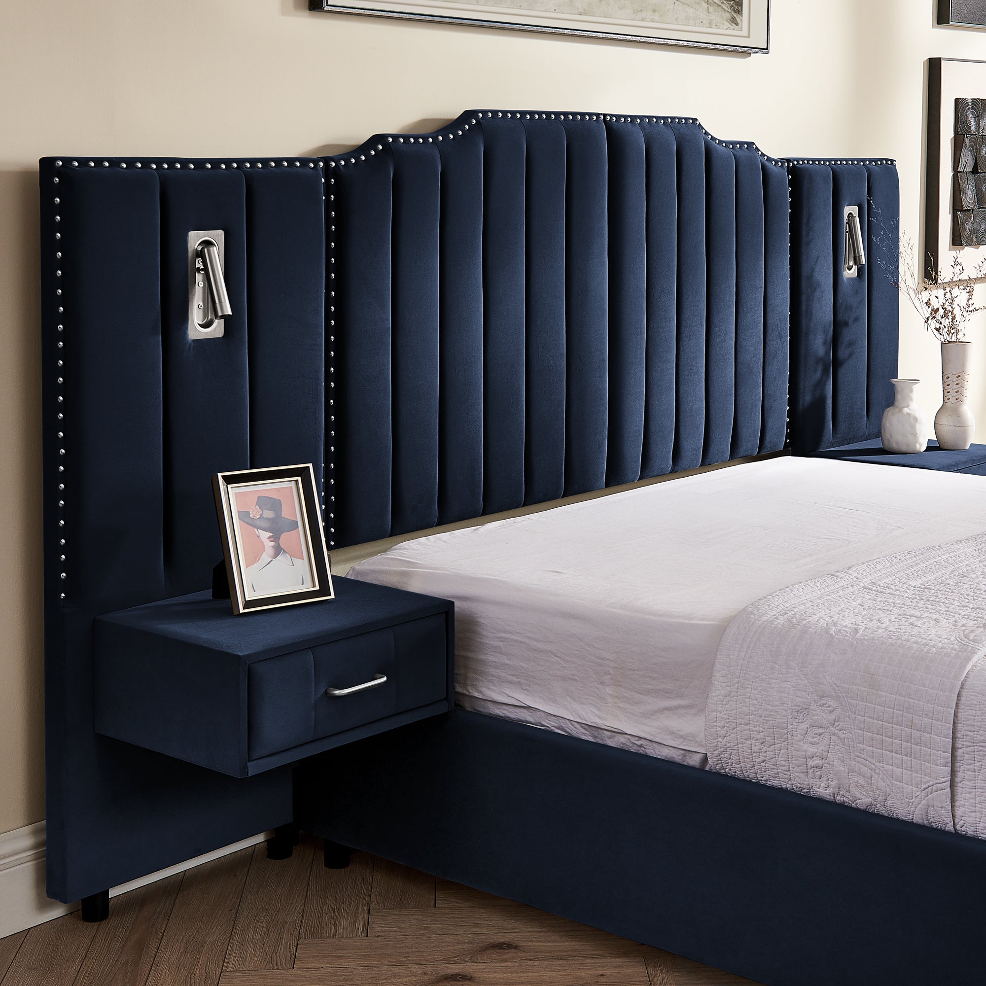 Close-up of navy velvet headboard with vertical tufting and built-in nightstand drawer on queen upholstered bed frame.