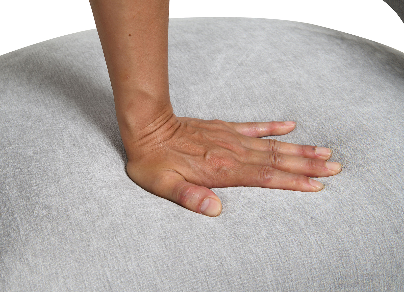 Hand pressing down on the cushioned seat of the contemporary arm chair, demonstrating its plush and supportive padding.