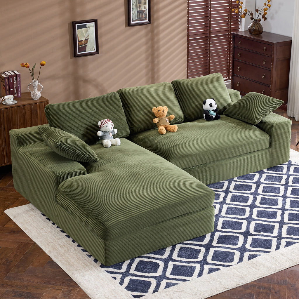 Angled top view of green corduroy sofa with plush pillows and soft cushions. Stylish and compact for home interiors.