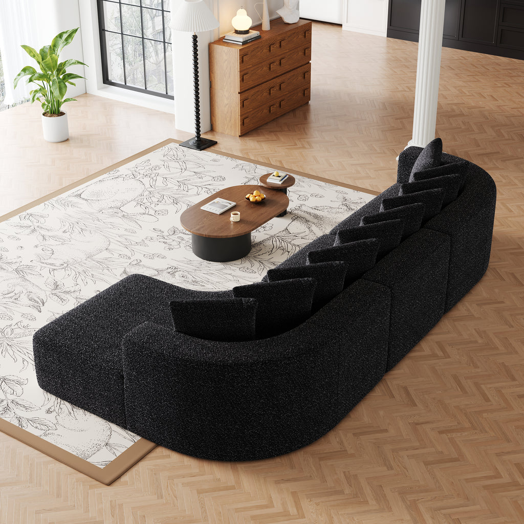 Chenille Sectional Sofa - Modular L-Shaped Sofa back view showing curved frame and plush pillows, styled in a modern open-plan living area.