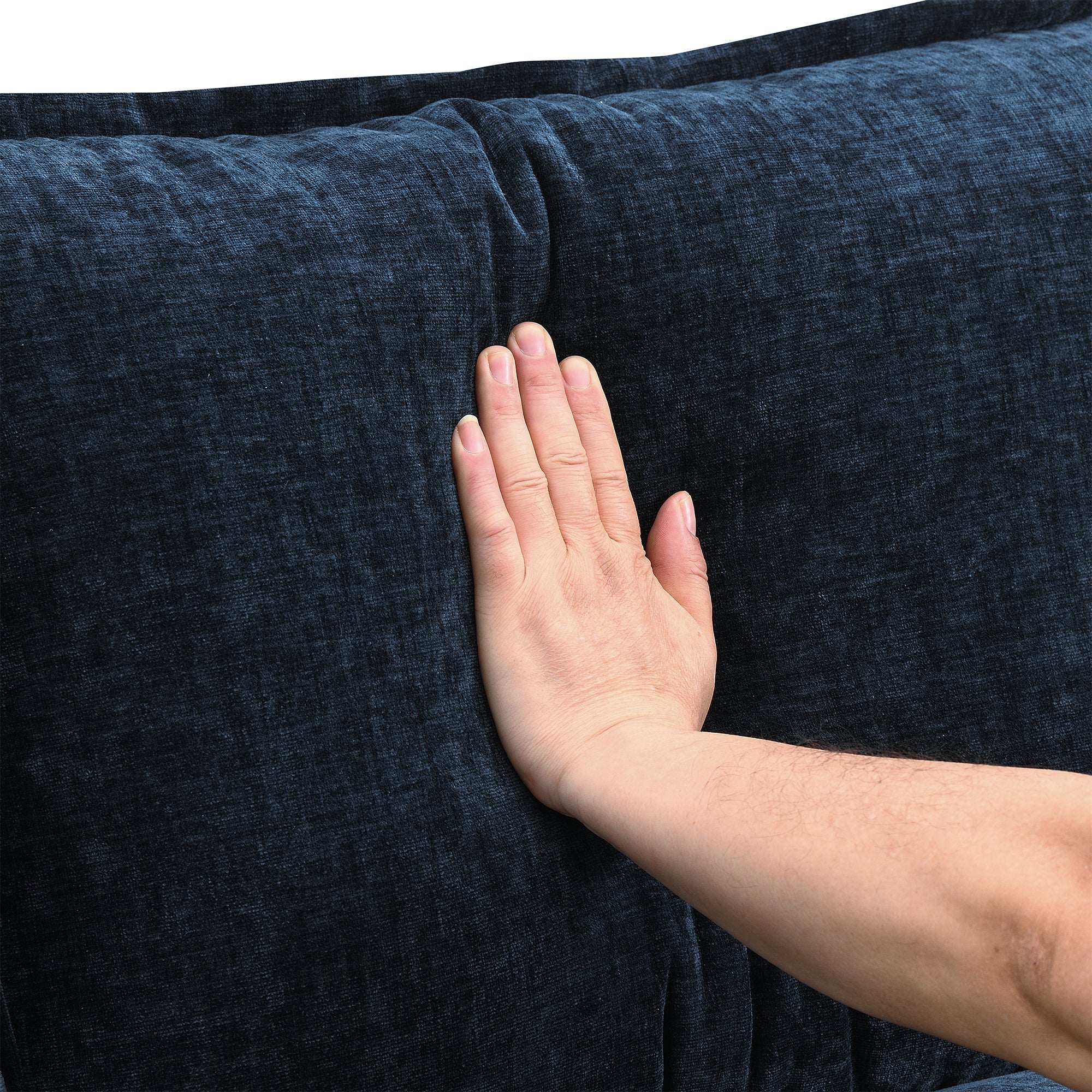 Hand pressing soft chenille cushion on U-shaped sectional sofa with USB charger, demonstrating plush texture and cozy support.