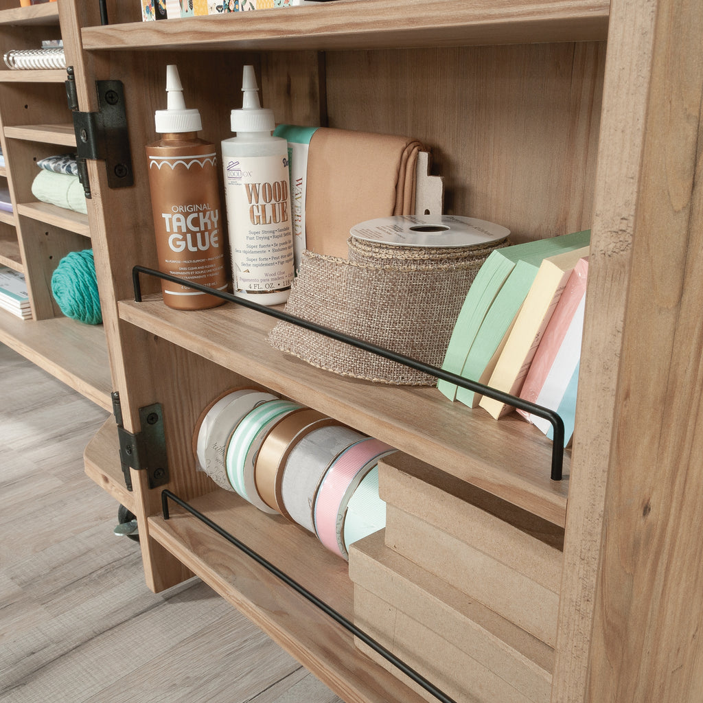 Door shelves of Craft Cart with Storage for Home storing glue, ribbon, and paper, maximizing vertical storage space.