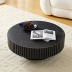 Modern round coffee table with 35.43'' sintered stone top, styled with books and decor in a contemporary living space.