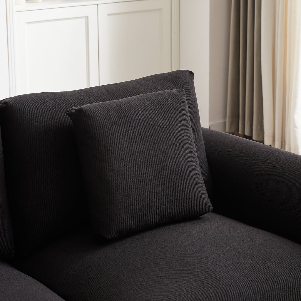 Detail of back cushion and armrest on modular L-shaped sofa with ottoman, showcasing fabric quality and comfort.