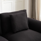 Detail of back cushion and armrest on modular L-shaped sofa with ottoman, showcasing fabric quality and comfort.