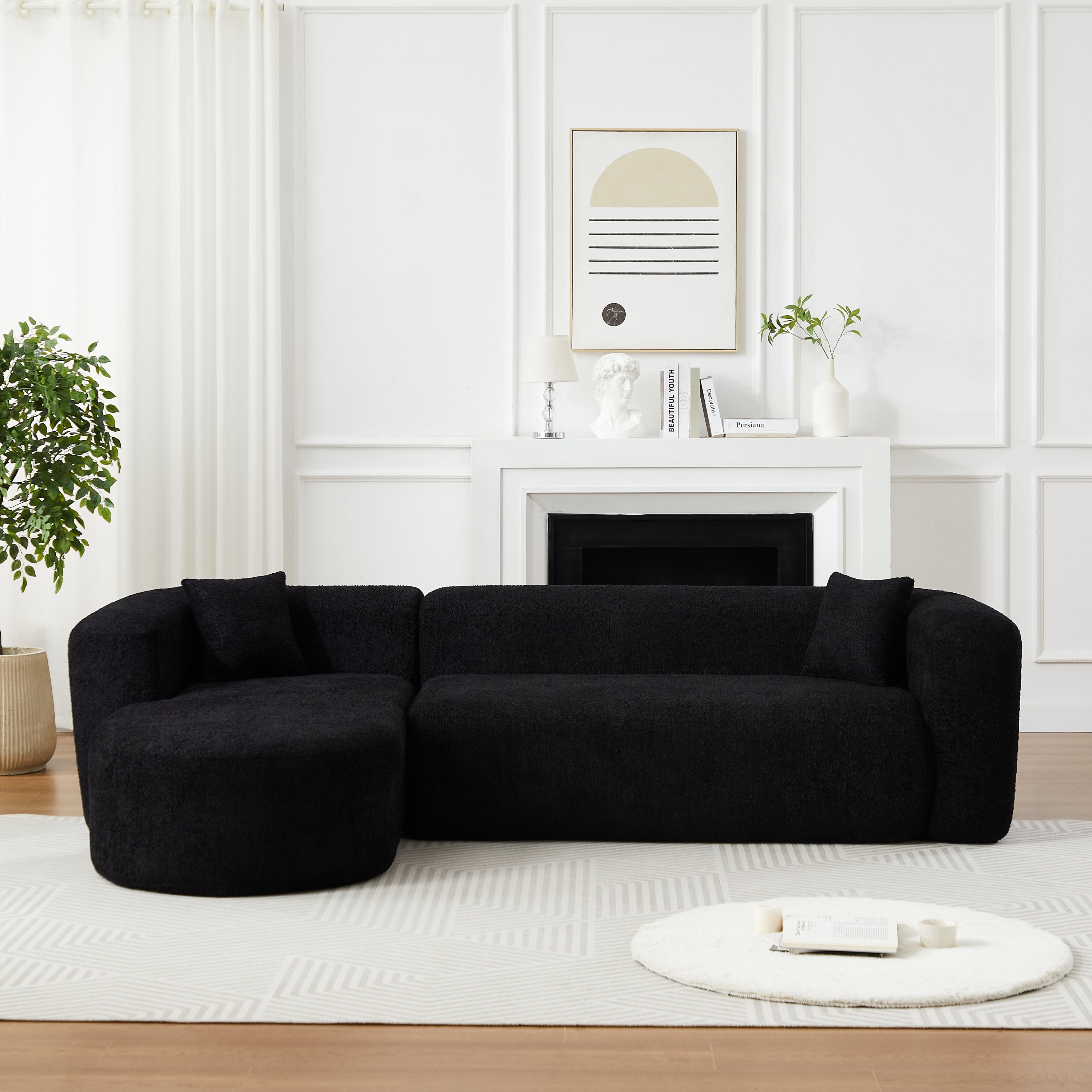 Chenille cloud couch with modular design and curved backrest, placed in a bright living room with fireplace and modern art.