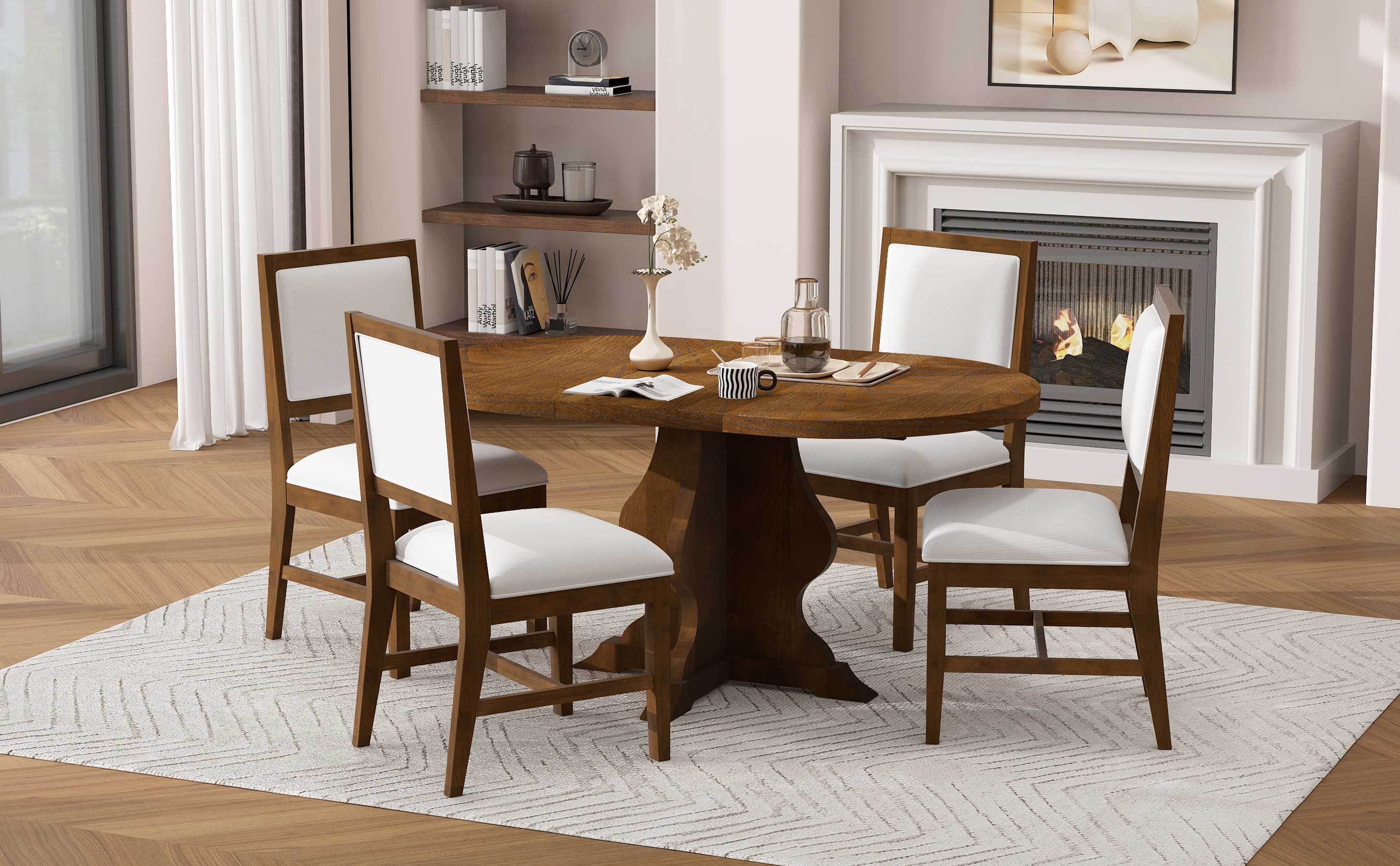 Rustic farmhouse dining set with round table and four upholstered chairs placed on a rug near a fireplace. Perfect for warm, inviting interiors.