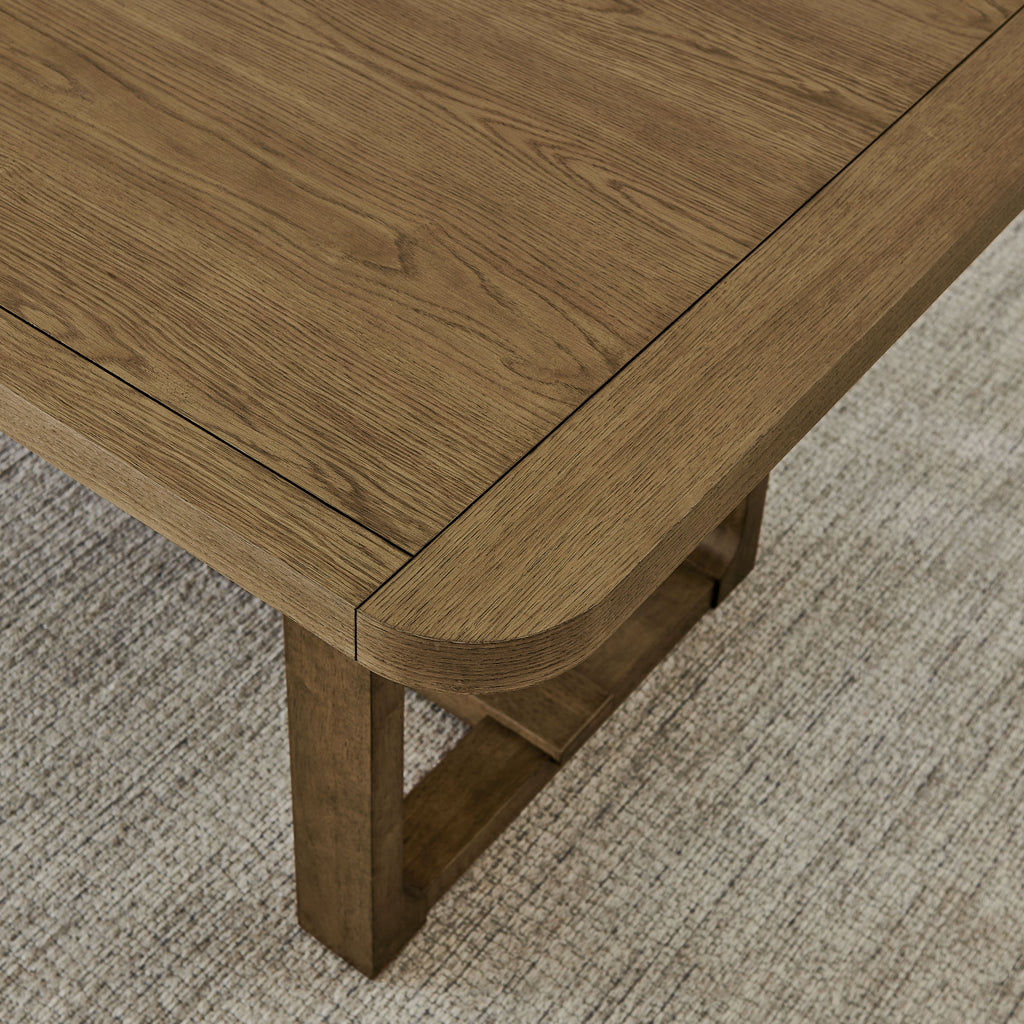 Close-up of Walnut Oak dining table corner showing wood grain texture and rounded edge, highlighting craftsmanship of the 7Pc Sled Dining Set.