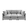 Modern grey chenille modular sectional sofa with plush cushions, accent pillows, and clean, contemporary lines.
