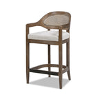 Angled view of Mid-Century Stool - Cane Back Modern highlighting wicker backrest, oak legs, and neutral cushioned seat.