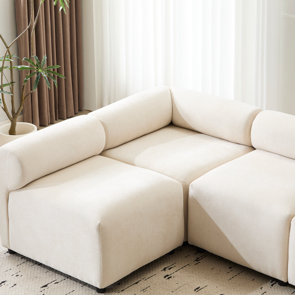 Corner section of the Evelyn U-Shaped Modular Sectional Sofa in a sunlit room, showcasing deep seats and cozy chenille fabric.