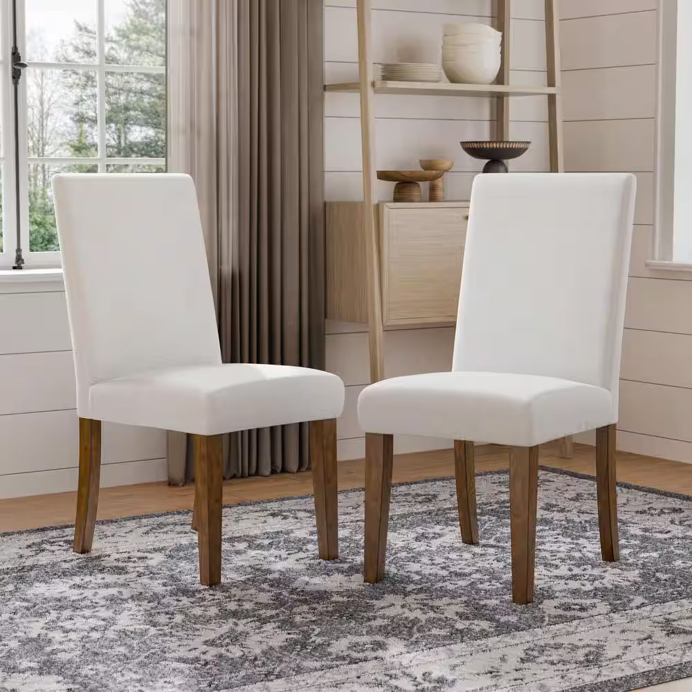 Rustic upholstered dining chairs 2pc set in a farmhouse-style room, showcasing white fabric and brown wooden legs for a warm, inviting look.