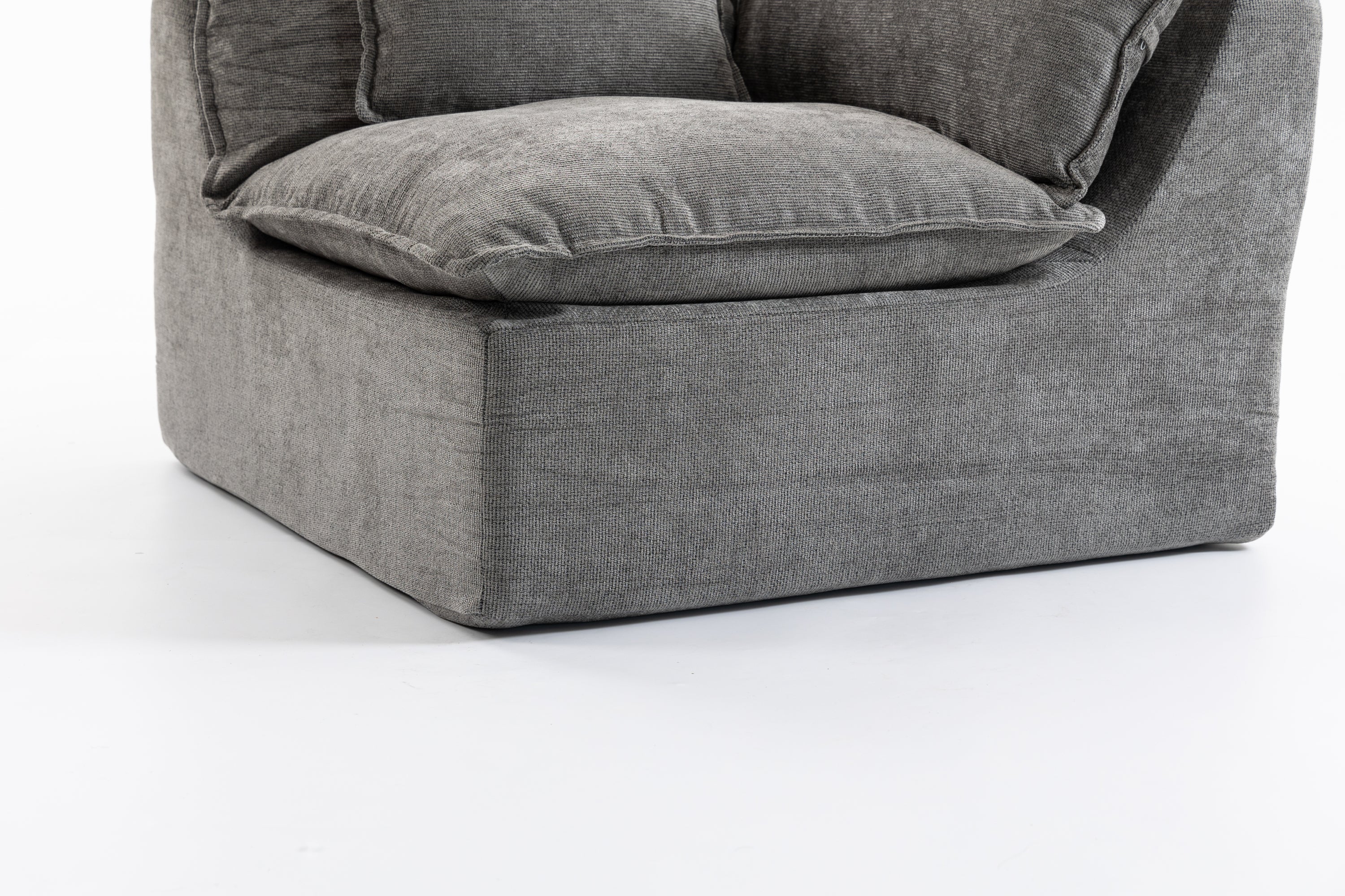 Close-up of the base of the Cloud Couch modular sectional showing durable grey velvet fabric and structured form.