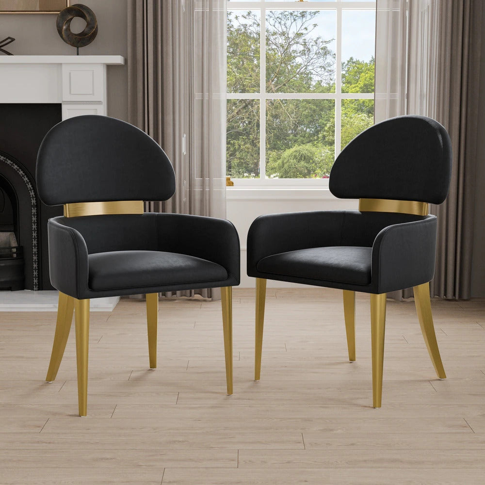 Pair of black dining arm chairs with gold legs placed in a modern living space, showcasing elegant and contemporary design.