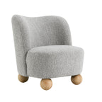 Gray boucle fabric accent chair with minimalist design and rounded wood legs, ideal for contemporary living room settings.